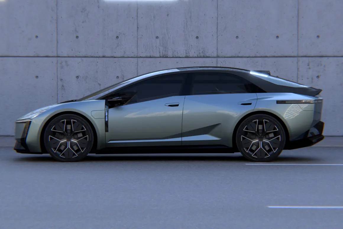 A sleek, futuristic car with a sculptural design and low profile, set against a concrete background.